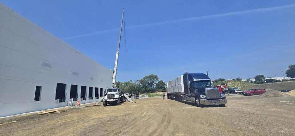 Warehouse long-reach setup with panels staged on the trailer