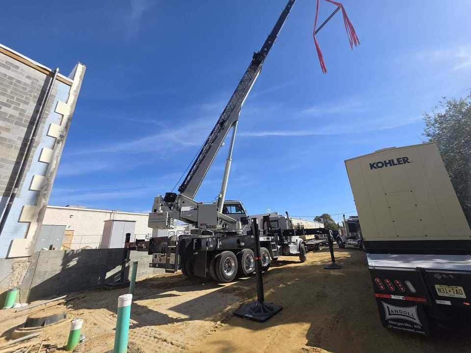 Standby generator staged for pad placement on a construction site