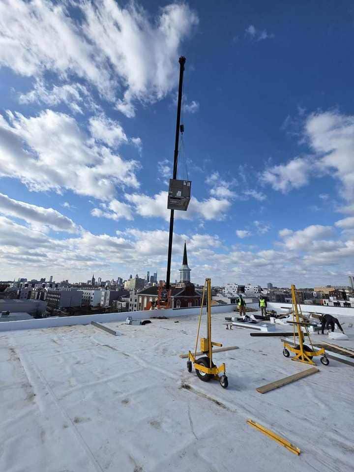 HVAC piece on the hook above a Philly rooftop