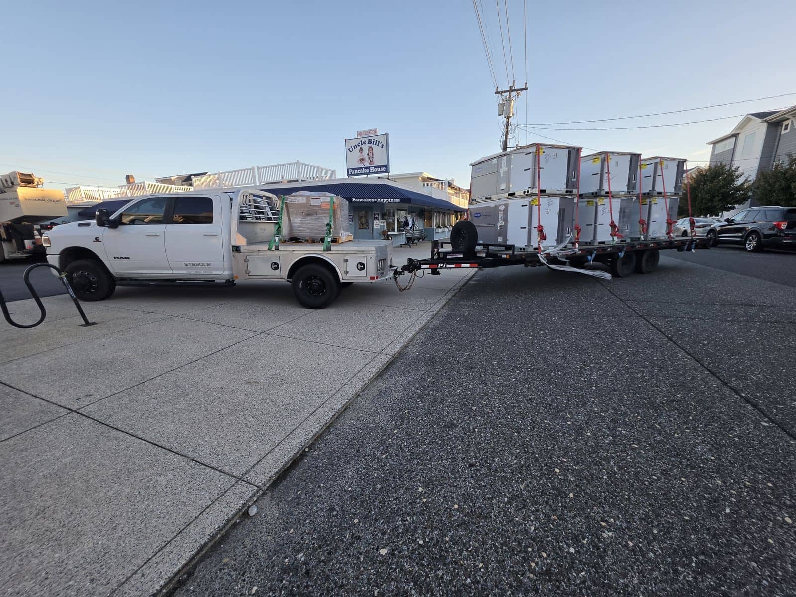 Steedle pickup truck and trailer loaded with new rooftop HVAC units in front of a breakfast restaurant in Ocean City, NJ