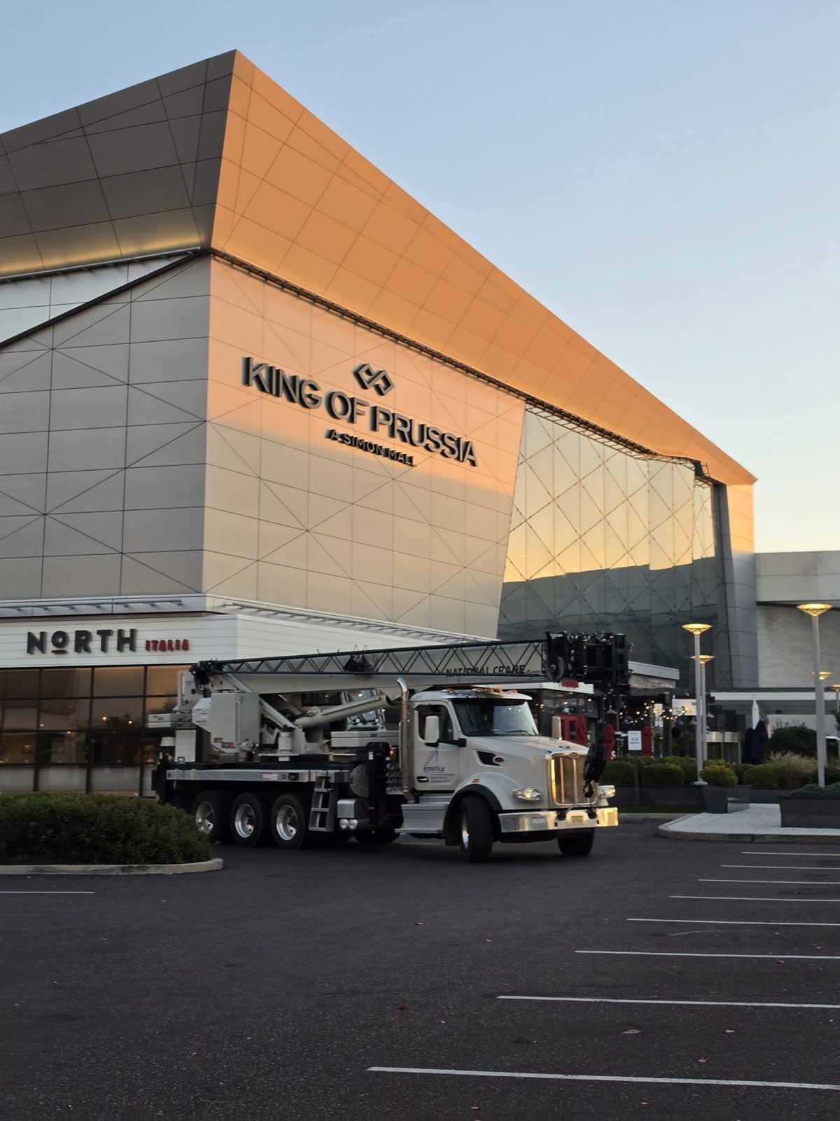 Steedle truck crane parked in front of the lit King of Prussia mall sign in King of Prussia, PA