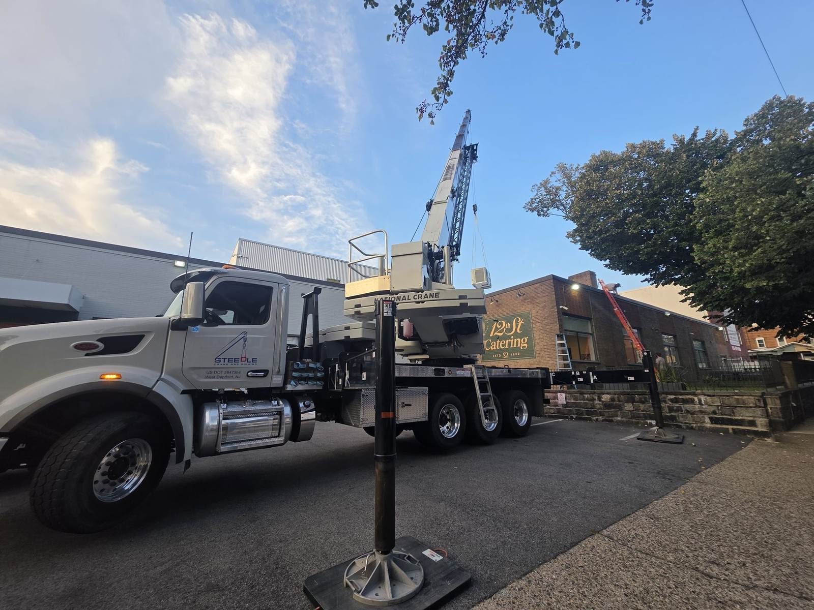 Steedle truck crane performing a lift on an open jobsite