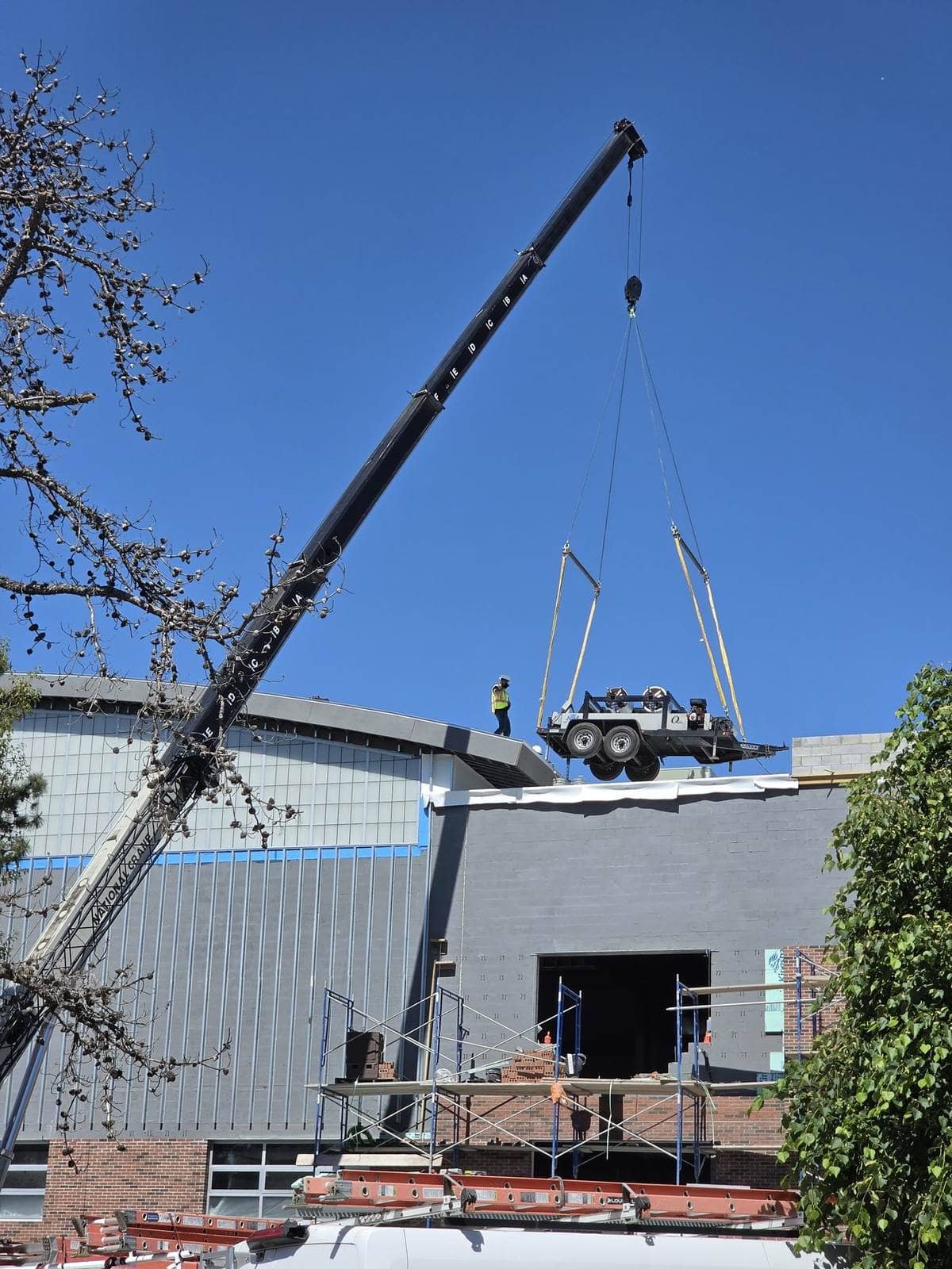 Compact machine / utility trailer set on a brick commercial roof