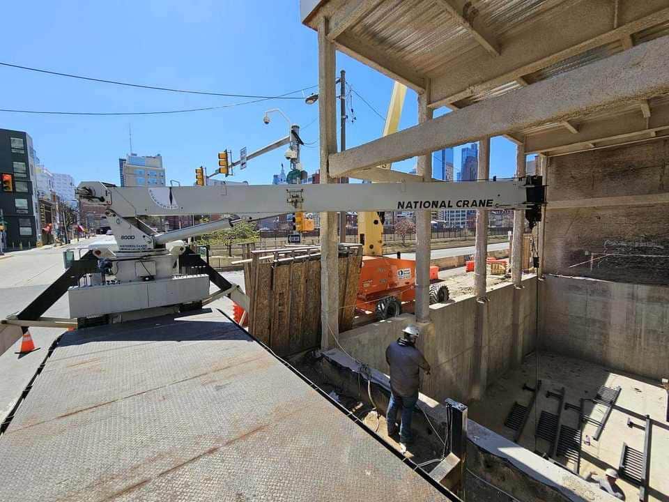 Crane assisting with urban construction placement