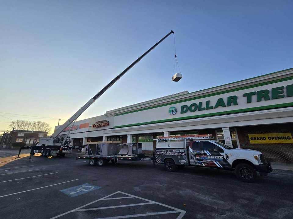 Crane performing a retail rooftop equipment lift