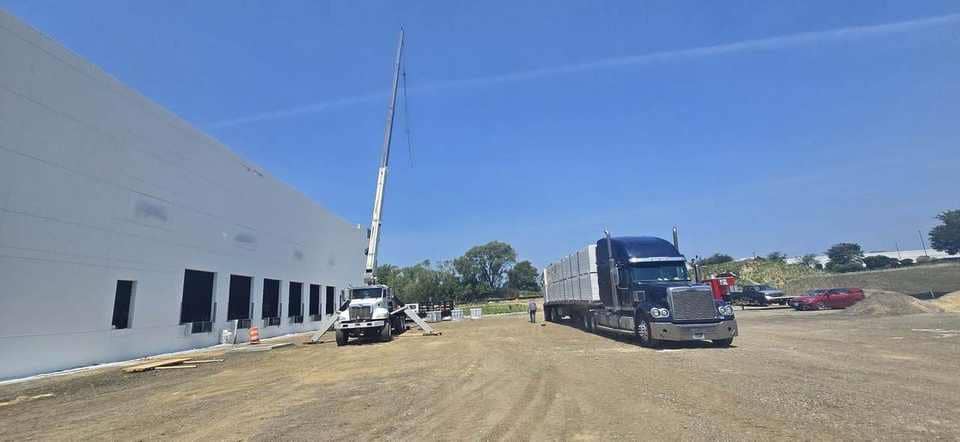 Warehouse long-reach setup with panels staged on the trailer