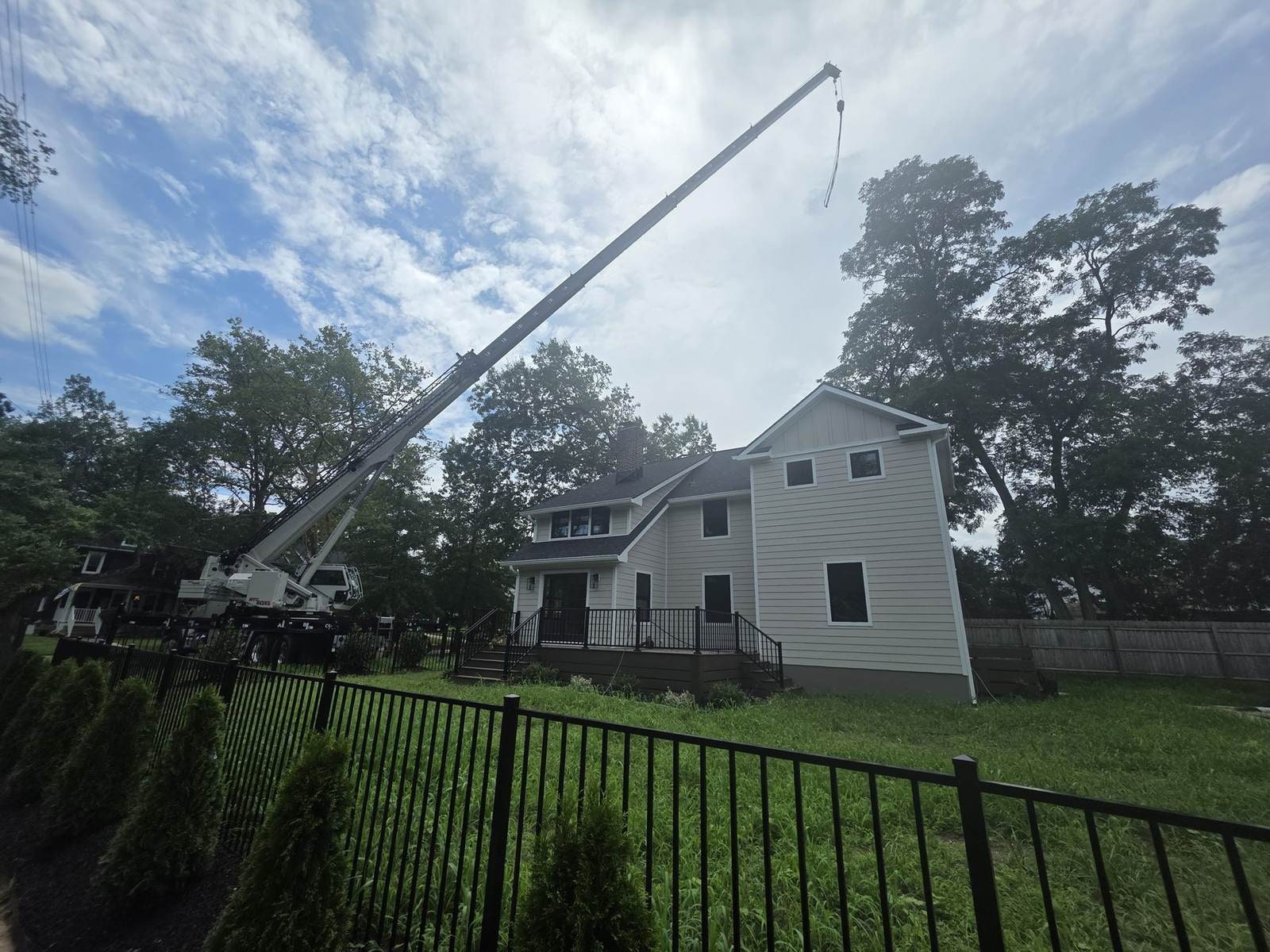 Residential crane lift near a house