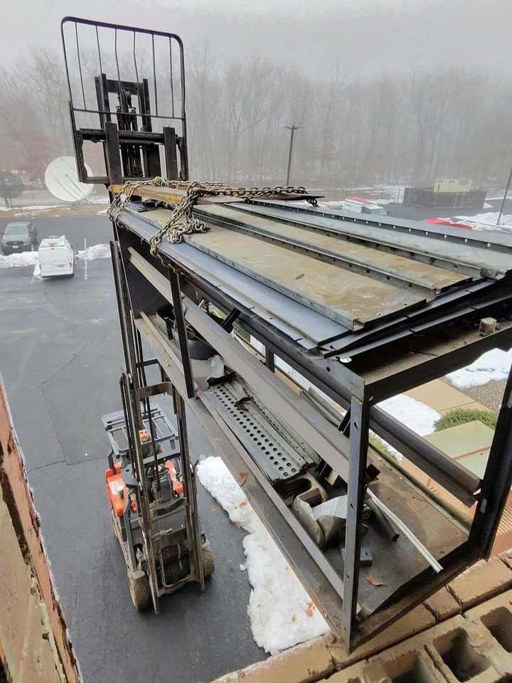 Forklift and chain rigging on a steel frame at a jobsite