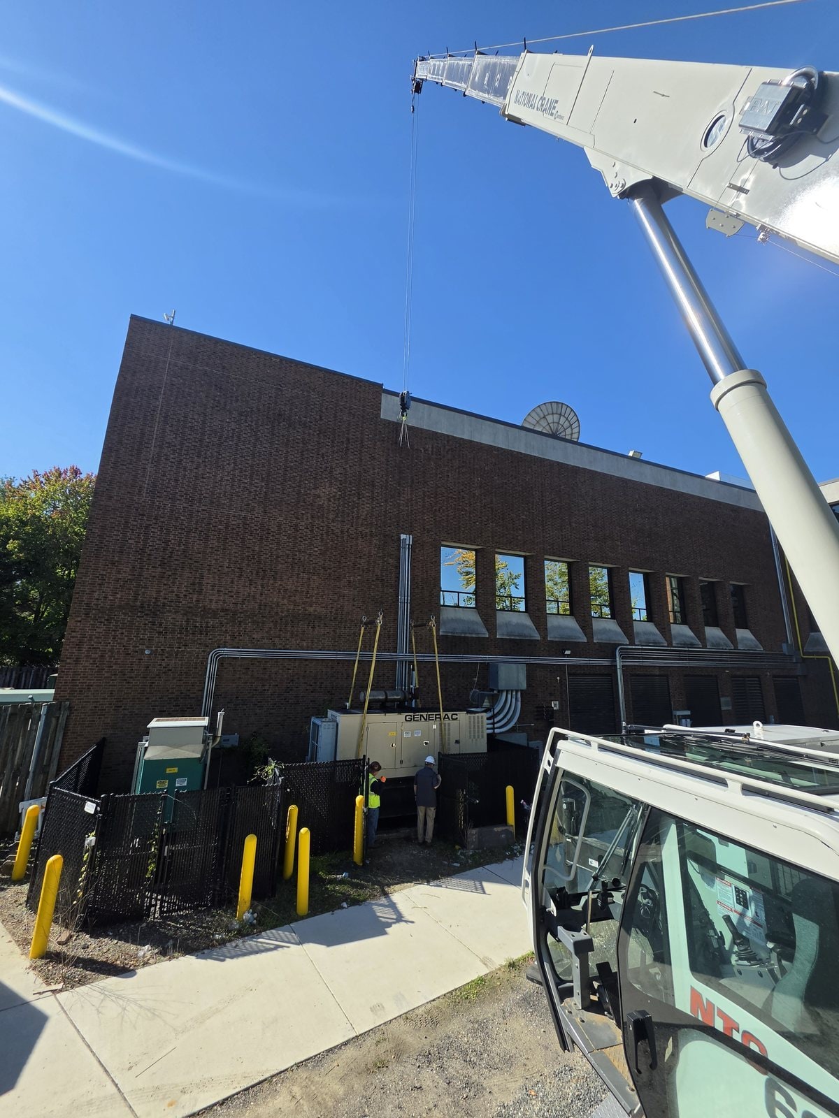 Truck crane lifting a Generac generator in Glassboro, NJ